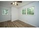Bedroom with light wood floors and two windows with bright natural light at 100 Colonial Dr, Goose Creek, SC 29445
