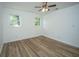 Bedroom featuring two windows, wood floors, a ceiling fan and white walls at 100 Colonial Dr, Goose Creek, SC 29445