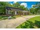 Well-maintained brick home featuring a long driveway and lush green lawn at 100 Colonial Dr, Goose Creek, SC 29445
