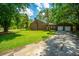 Charming brick home with attached garage, well-maintained lawn, and paved driveway at 100 Colonial Dr, Goose Creek, SC 29445