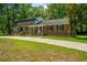 Charming brick home with a well-manicured lawn and mature trees, perfect curb appeal at 100 Colonial Dr, Goose Creek, SC 29445