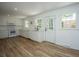 Bright kitchen featuring white cabinetry and stainless steel appliances and wood floors at 100 Colonial Dr, Goose Creek, SC 29445