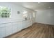 Bright kitchen with modern white cabinetry, stainless steel dishwasher, and wood floors at 100 Colonial Dr, Goose Creek, SC 29445
