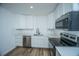 Modern kitchen featuring white cabinets, stainless steel appliances, and quartz countertops at 100 Colonial Dr, Goose Creek, SC 29445