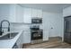 Well-equipped kitchen featuring stainless steel appliances, stone countertops, and ample cabinetry at 100 Colonial Dr, Goose Creek, SC 29445