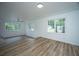 Open-concept living area featuring wood floors and large windows at 100 Colonial Dr, Goose Creek, SC 29445