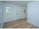 Neutral room features classic floors, light walls, bright windows, and a back door view at 100 Colonial Dr, Goose Creek, SC 29445