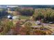 Stunning aerial view showcasing the community's pond, wooden bridge, and surrounding trees at 1013 Sagegrass St, Summerville, SC 29485