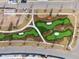 Aerial view shows a putting green in a parklike setting alongside the street in this planned community at 1013 Sagegrass St, Summerville, SC 29485