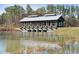Scenic view of a wooden structure over a pond, surrounded by lush greenery at 1013 Sagegrass St, Summerville, SC 29485