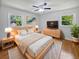 Inviting bedroom with wood floors, a ceiling fan, and soft lighting, creating a restful retreat for homeowners at 102 Rebellion Rd, Summerville, SC 29483