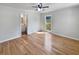A bedroom featuring hardwood floors, a ceiling fan, and an ensuite bathroom at 102 Rebellion Rd, Summerville, SC 29483