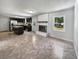 Open-concept kitchen with stainless steel appliances, dark cabinetry, tile floors, and a fireplace, creating a modern look at 102 Rebellion Rd, Summerville, SC 29483