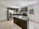 Spacious kitchen with stainless steel appliances, a large island, tile backsplash and floors, perfect for cooking at 102 Rebellion Rd, Summerville, SC 29483