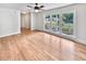 Bright living room featuring hardwood floors and large windows offering a view of the well-maintained neighborhood at 102 Rebellion Rd, Summerville, SC 29483