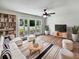 Bright living room featuring large windows, hardwood floors, and modern furnishings, creating a cozy atmosphere at 102 Rebellion Rd, Summerville, SC 29483