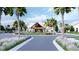 Grand clubhouse entrance with manicured landscaping, palm trees, and a circular driveway at 1037 Tulip Shell St, Summerville, SC 29485
