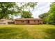 Spacious backyard featuring a well-maintained lawn and a classic brick home at 104 Belmont Ct, Ladson, SC 29456