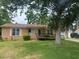 Charming single-story brick home featuring a well-maintained lawn, mature trees, and a convenient ramp at 104 Belmont Ct, Ladson, SC 29456