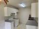 Functional kitchen space with white cabinetry, ample counter space, and a checkered pattern floor at 104 Belmont Ct, Ladson, SC 29456
