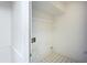 Laundry room with white walls, shelving, washer hookups, and black and white tile floors at 104 Belmont Ct, Ladson, SC 29456
