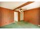 Living room featuring wood paneling, beamed ceiling, ceiling fan, and doorway to a hall at 104 Belmont Ct, Ladson, SC 29456