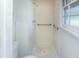 Shower with a showerhead, safety bars, and tiled walls at 104 Belmont Ct, Ladson, SC 29456