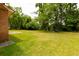 Expansive yard with lush green grass and a brick home at 104 Belmont Ct, Ladson, SC 29456