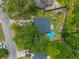 Aerial view of the backyard featuring a pool, surrounded by mature trees and a playset at 104 Greensboro Ln, Ladson, SC 29456