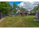Spacious backyard featuring lush green grass, a wooden playset, and a fenced perimeter for privacy at 104 Greensboro Ln, Ladson, SC 29456