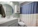 This bathroom features a vanity, toilet, shower and tub combination with a blue striped shower curtain at 104 Greensboro Ln, Ladson, SC 29456