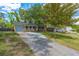Single-story home with blue garage door, quaint front porch, and long driveway at 104 Greensboro Ln, Ladson, SC 29456