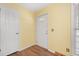 The hallway has wood floors, a white front door, and is painted in a bright yellow at 104 Greensboro Ln, Ladson, SC 29456