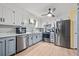 A modern kitchen with stainless steel appliances, tile backsplash and a ceiling fan at 104 Greensboro Ln, Ladson, SC 29456