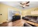 The living room features a large sectional, ceiling fan, TV and light wood floors at 104 Greensboro Ln, Ladson, SC 29456