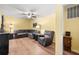 The living room features a large sectional, ceiling fan and light wood floors at 104 Greensboro Ln, Ladson, SC 29456