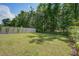 Large, grassy backyard enclosed by a white fence, offering privacy and space for recreation at 1059 Sago Palm Ct, Mount Pleasant, SC 29429
