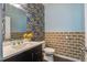 Half bathroom featuring floral wallpaper, tiled wainscoting, and a modern vanity at 1059 Sago Palm Ct, Mount Pleasant, SC 29429