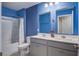 Bathroom featuring a double vanity, walk-in tub, and blue accent wall at 1059 Sago Palm Ct, Mount Pleasant, SC 29429