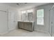 Bright bathroom featuring double vanity with grey cabinets and glass-enclosed shower at 1059 Sago Palm Ct, Mount Pleasant, SC 29429