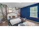 bedroom featuring a full-sized bed with tropical wallpaper and a bright blue accent wall at 1059 Sago Palm Ct, Mount Pleasant, SC 29429