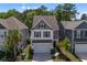 Beautiful two-story home featuring a neutral color scheme, attached two-car garage, and manicured landscaping at 1059 Sago Palm Ct, Mount Pleasant, SC 29429