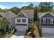 Two-story home with a two-car garage, attractive landscaping, and a well-manicured lawn at 1059 Sago Palm Ct, Mount Pleasant, SC 29429