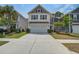 Charming home with a two-car garage, manicured lawn, and a long driveway at 1059 Sago Palm Ct, Mount Pleasant, SC 29429