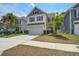 Inviting two-story house with a well-kept lawn, two-car garage, and charming curb appeal at 1059 Sago Palm Ct, Mount Pleasant, SC 29429