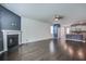 Bright living room featuring fireplace, hardwood floors, and views of the open-concept kitchen at 1059 Sago Palm Ct, Mount Pleasant, SC 29429