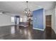 Open floor plan featuring hardwood floors, modern chandelier, and view of kitchen at 1059 Sago Palm Ct, Mount Pleasant, SC 29429