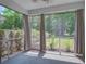 Relaxing screened-in porch with sheer curtains, offering a view of the private backyard at 1059 Sago Palm Ct, Mount Pleasant, SC 29429