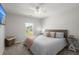 The bright bedroom has a plush bed, ceiling fan, and a window with a view of the neighborhood at 110 Levis Song Ct, Goose Creek, SC 29445