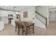 Inviting dining area with a wood table adjacent to a modern kitchen and staircase at 110 Levis Song Ct, Goose Creek, SC 29445